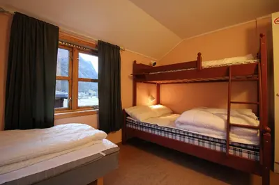 a bedroom with two bunk beds and a window at Åndalsnes Hostel in Åndalsnes