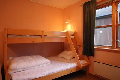 two bunk beds in a room with a window at Åndalsnes Hostel in Åndalsnes