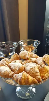 a plate of pastries on a table with two bowls at Blåtind Boutique Hotel in Stordal