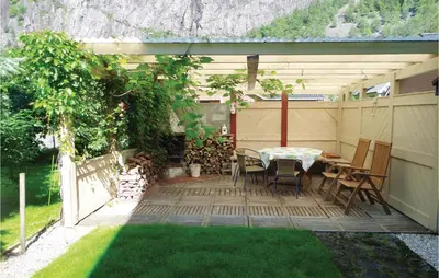 a patio with a table and chairs and a fence at 3 Bedroom Lovely Home In Fjæra in Fjæra