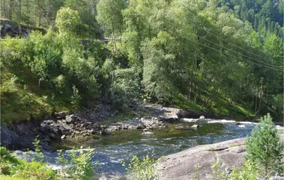a river in the middle of a forest at 3 Bedroom Lovely Home In Fjæra in Fjæra