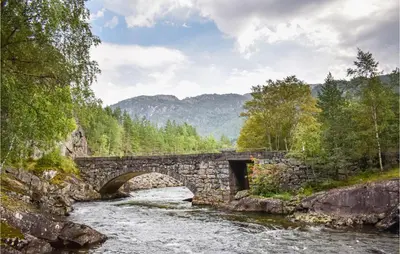 a stone bridge over a river in the mountains at 3 Bedroom Lovely Home In Fjæra in Fjæra