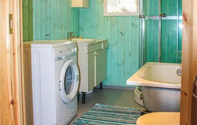 a bathroom with a washing machine and a sink at Three-Bedroom Holiday Home In Heidal in Heidal