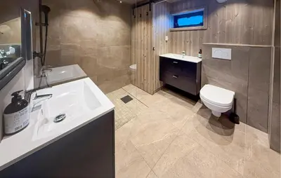a bathroom with a sink and a toilet at Nice Home In Hovden With Sauna in Hovden