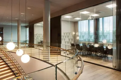 a dining room with a glass table and chairs at Scandic Flesland Airport in Bergen