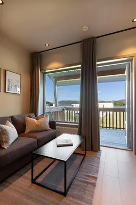 a living room with a couch and a table at Bjugn Hotell in Botngard