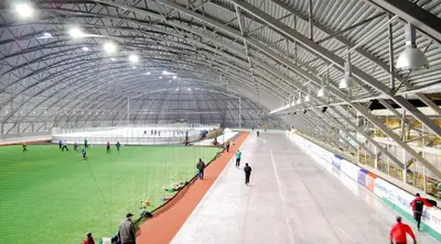 a large stadium with people walking around a green field at Bjugn Hotell in Botngard