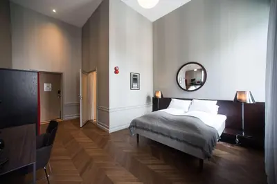 a hotel room with a bed and a mirror at Bergen Børs Hotel in Bergen