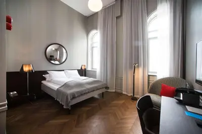 a bedroom with a bed and a mirror at Bergen Børs Hotel in Bergen