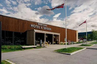 a building with two flags in front of it at Thon Hotel Vinstra in Vinstra