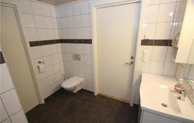 a bathroom with a toilet and a sink at 3 Bedroom Stunning Home In Sjusjøen in Sjusjøen