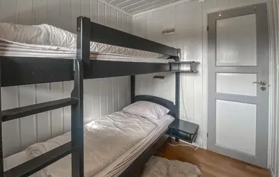 a room with two bunk beds and a door at Cozy Home In Sjusjøen in Sjusjøen