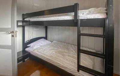 a couple of bunk beds in a room at Cozy Home In Sjusjøen in Sjusjøen
