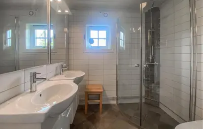 a bathroom with two sinks and a shower at Cozy Home In Sjusjøen in Sjusjøen