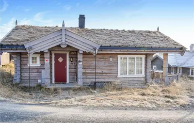 an old wooden house with a red door at 3 Bedroom Nice Home In Sjusjøen in Sjusjøen