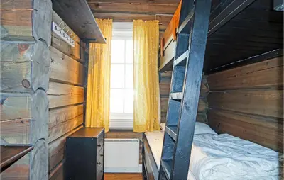 a bedroom with a bunk bed and a window at 3 Bedroom Nice Home In Sjusjøen in Sjusjøen