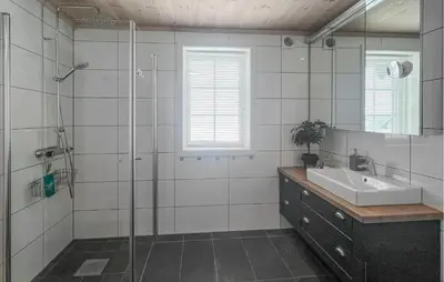 a bathroom with a glass shower and a sink at Cozy Home In Sjusjøen With Sauna in Sjusjøen