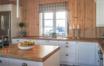 a kitchen with a bowl of fruit on a counter at Cozy Home In Sjusjøen With Sauna in Sjusjøen