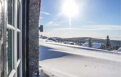 a window view of a snow covered road at Cozy Home In Sjusjøen With Sauna in Sjusjøen