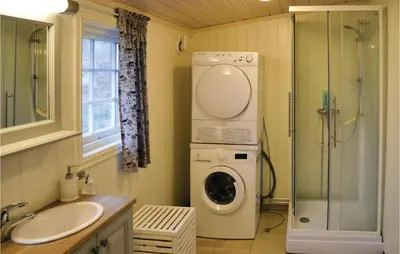 a bathroom with a washing machine and a sink at Three-Bedroom Holiday Home In Sjusjoen in Sjusjøen