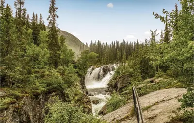 a waterfall in the middle of a forest at Gorgeous Apartment In Hemsedal in Hemsedal