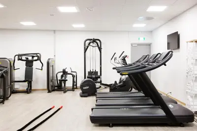 a gym with treadmills and elliptical machines at Comfort Hotel Bergen Airport in Bergen