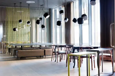 a restaurant with tables and chairs and large windows at Comfort Hotel Bergen Airport in Bergen