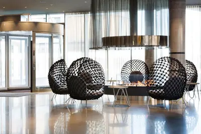 a group of chairs sitting in a room with a table at Comfort Hotel Bergen Airport in Bergen