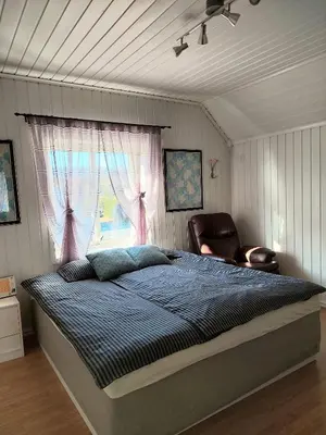 a bedroom with a bed and a window at Egil's Vacation House in Lillehammer