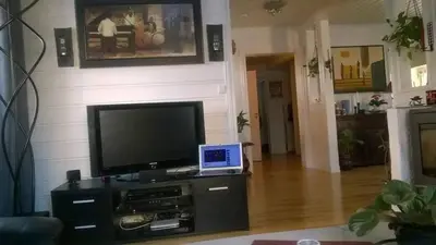 a living room with a television and a laptop on a table at Egil's Vacation House in Lillehammer