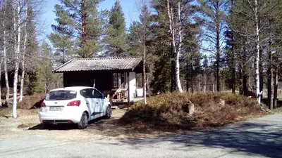 a white car parked in front of a small building at Sæteråsen Hytter & Camping Trysil in Trysil