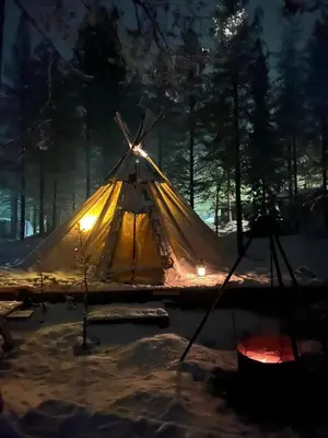 a lit up tent in the snow at night at Sæteråsen Hytter & Camping Trysil in Trysil