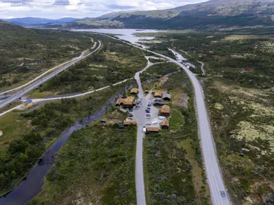 an aerial view of a road next to a river at Dovregubbens Hall in Vålåsjø