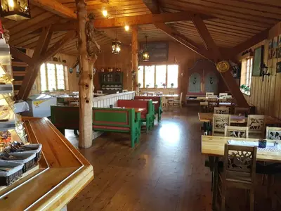 a large room with tables and chairs in a building at Dovregubbens Hall in Vålåsjø