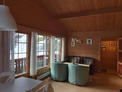 a living room with a couch and some windows at Magalaupe Camping in Oppdal