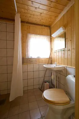 a bathroom with a toilet and a sink at Magalaupe Camping in Oppdal