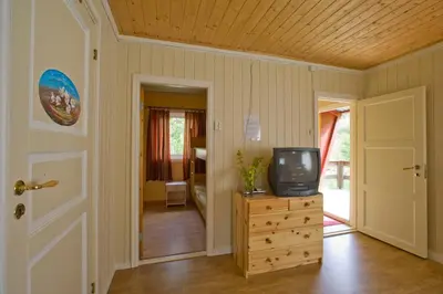 a room with a television on a wooden dresser at Magalaupe Camping in Oppdal
