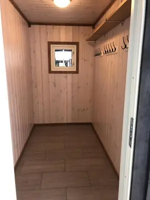 a small room with a window in a wooden wall at Haglebu Turistheim in Haglebu