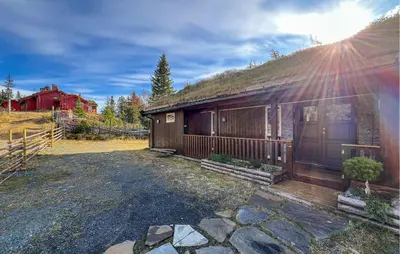 a house with a grassy roof with a stone driveway at Sjusjøen-Pihl 89 in Sjusjøen