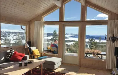 a living room with a large window with a view at Sjusjøen Pihl 4020 in Sjusjøen