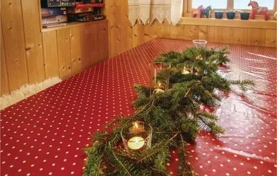 a christmas tree on a table with a red floor at Gorgeous Home In Sjusjøen With Sauna in Sjusjøen