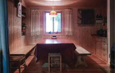 a dining room with a table and a window at Gorgeous Home In Sjusjøen With Sauna in Sjusjøen