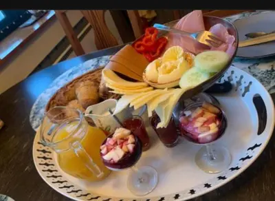 a plate of food on a table with drinks at Kylstad Bed and Breakfast in Kylstad