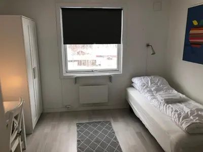 a small room with a bed and a window at Vinstra Hostel in Vinstra