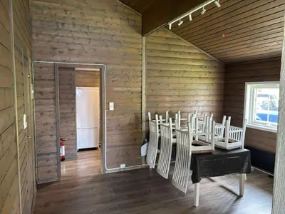 a room with white chairs in a room with a mirror at Skottneset Feriesenter in Barmen