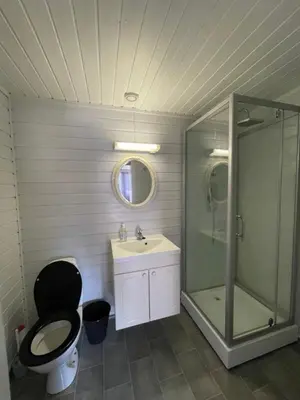 a bathroom with a toilet and a sink and a shower at Skottneset Feriesenter in Barmen