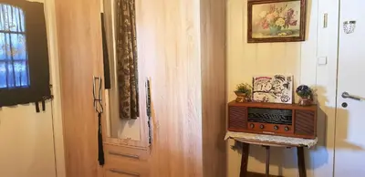 a kitchen with a microwave next to a door at Berge & Laila's Private Apartment in Førde