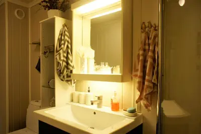 a bathroom with a sink and a mirror at Berge & Laila's Private Apartment in Førde