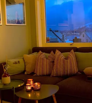a living room with a couch and a window at City View Studio Apartment in Ålesund