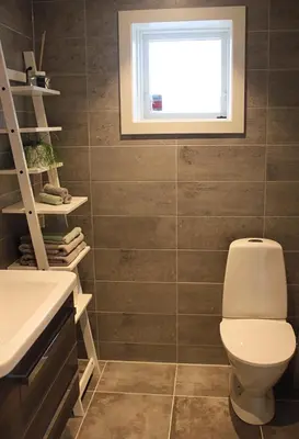 a bathroom with a toilet and a window at City View Studio Apartment in Ålesund